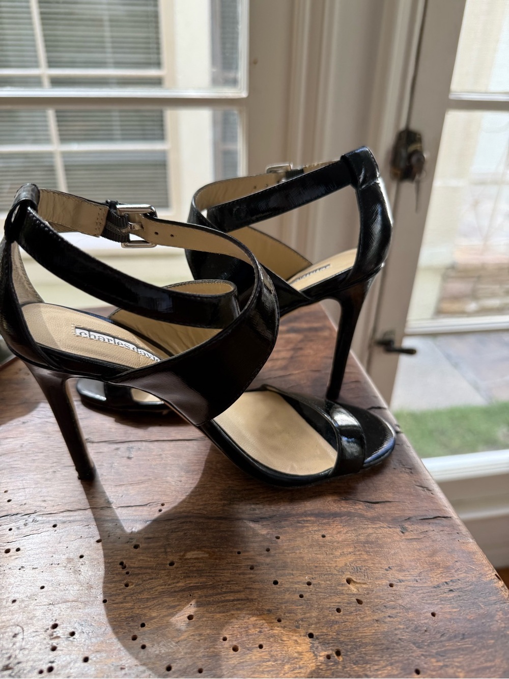 Charles David black patent leather open toe strapped high heel sandals.